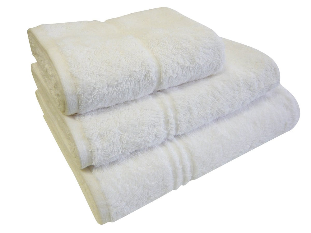 Stack of white EcoKnit towels — bath sheet, bath towel and hand towel
